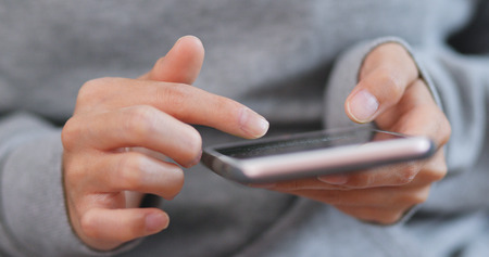 Close up of woman use of mobile phoneの写真素材