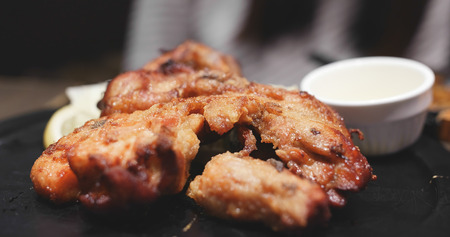 Grilled chicken thigh on plate in restaurant の写真素材
