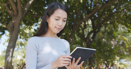 Woman use of tablet computer at outdoor の写真素材