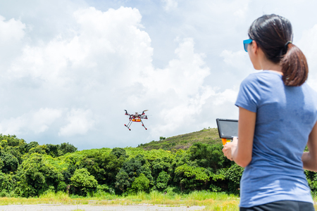 Woman playing drone at outdoorの写真素材