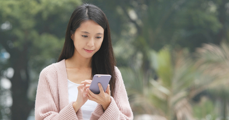 Woman using mobile phone の写真素材