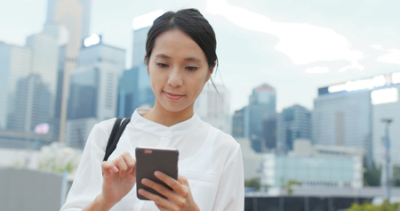 Business woman use of smart phone in city の写真素材