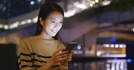 Woman use of mobile phone at outdoor の写真素材