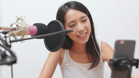 Woman talking on cellphone with live stream の写真素材