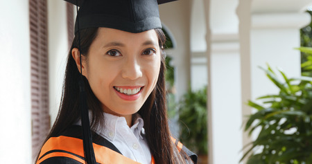 Young woman get graduation in university campus の写真素材