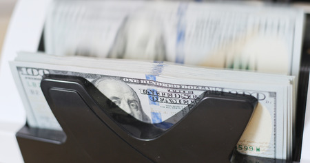 America banknote on automatic counting machine 