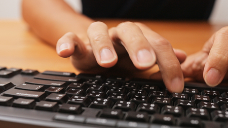 Working on laptop computer の写真素材