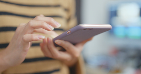 Woman using smart phone の写真素材
