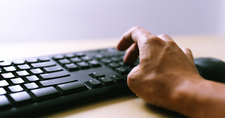 Fingers typing on keyboard の写真素材