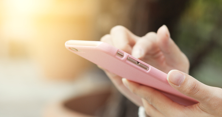 Woman use of smart phone at outdoor の写真素材