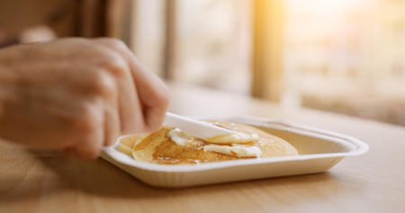 Haivng pancake at coffee shop の写真素材