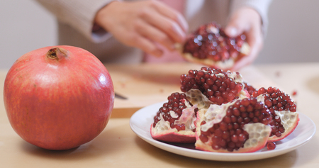 Pick pomegranate seed into glass の写真素材