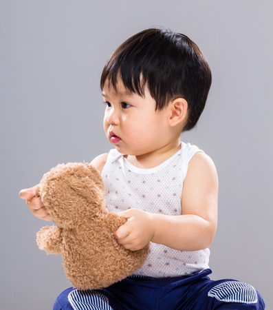 Baby boy play with toy bearの写真素材