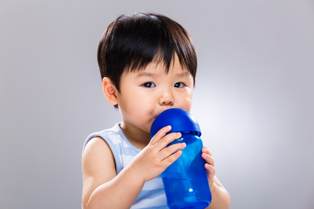 Asian baby drinking waterの写真素材