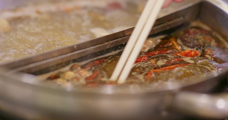 Spicy chinese hotpot in restaurantの写真素材