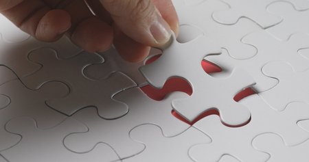 Completing the white puzzleの写真素材