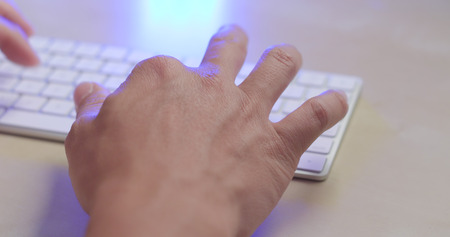Man working on keyboard at home