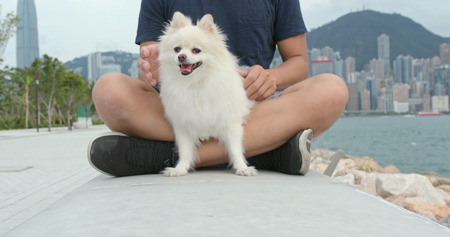 Man hugging his dog at outdoorの写真素材
