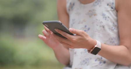 Woman use of cellphone in city park