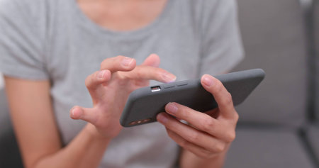 Woman play game on cellphone at home