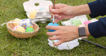 Drawing on egg for Easter holiday at outdoor