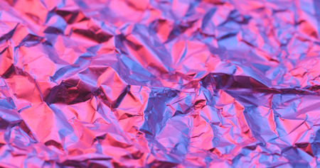 Wrinkle aluminum foil texture with purple lightの写真素材