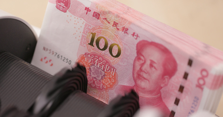 Money counting machine with Chinese hundred RMBの写真素材