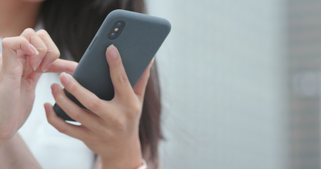 Using smart phone at outdoorの写真素材