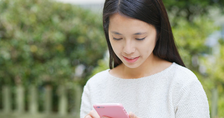 Woman use of mobile phone in cityの写真素材