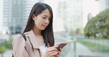 Asian woman use of mobile phone at outdoorの写真素材