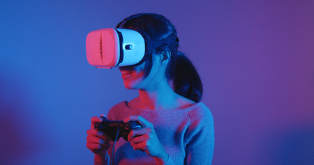 Woman play game with VR deviceの写真素材
