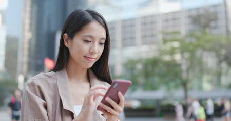 Woman use of smart phone in cityの写真素材
