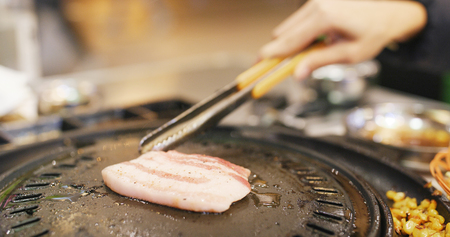 Grilled Korean BBQ in restaurantの写真素材