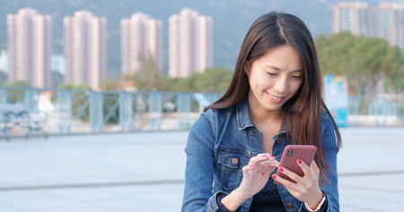 Woman use of mobile phone for online messageの写真素材