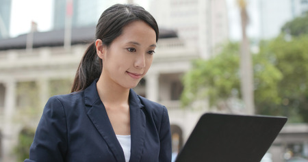 Businesswoman work on laptop computer at outdoorの写真素材
