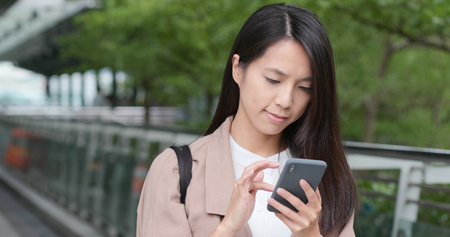 Woman use of mobile phone in cityの写真素材