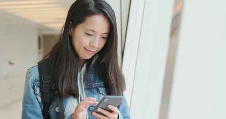 Woman use of mobile phone in cityの写真素材