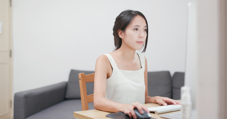 Woman working on computer at homeの写真素材