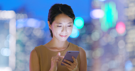 Woman use of smart phone in cityの写真素材