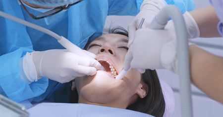 Dentist examines the patient teethの写真素材