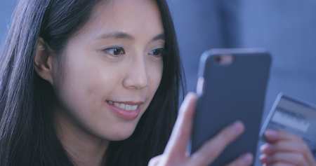 Woman using cellphone for shopping online by credit cardの写真素材