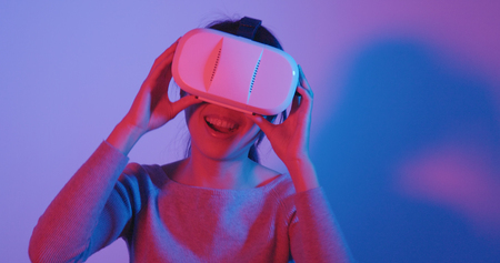 Woman look though the VR deviceの写真素材
