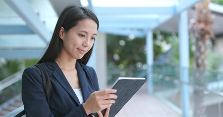 Business woman using digital tablet at outdoorの写真素材