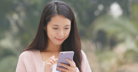 Woman looking at mobile phoneの写真素材