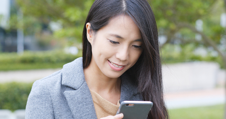 Woman using smart phone in cityの写真素材