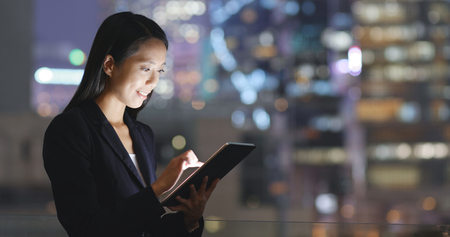 Business woman working on digital tablet in the cityの写真素材