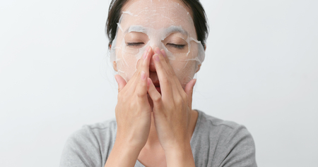 Woman apply facial maskの写真素材