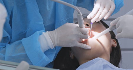 Dentist examining woman teethの写真素材