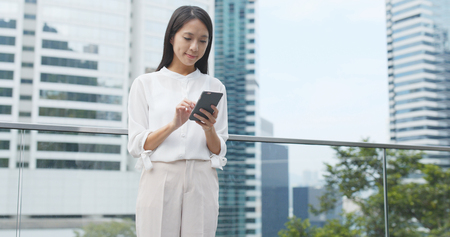Business woman using mobile phoneの写真素材