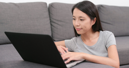 Woman working on laptop at homeの写真素材
